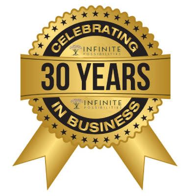 This image shows a gold-colored, circular anniversary seal with ribbons and stars, celebrating "30 YEARS IN BUSINESS" with the slogan "Celebrating Infinite Possibilities."