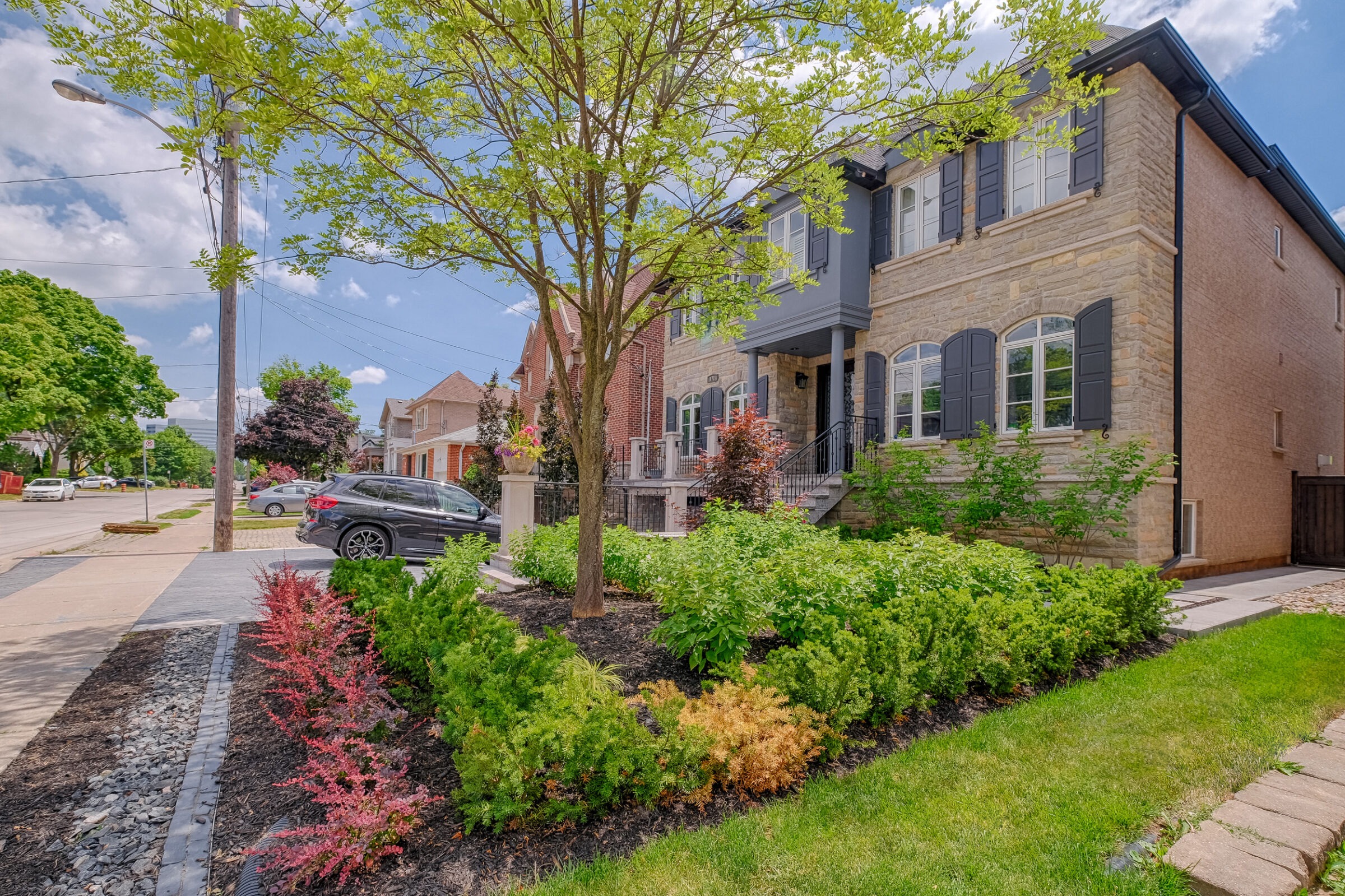 Front yard landscaping in Toronto featuring some beautifully arranged greenery.