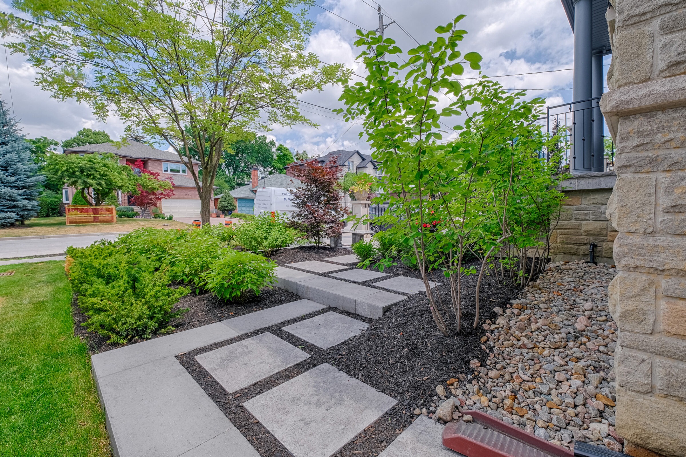 Front yard landscaping in Toronto featuring a custom stone path.