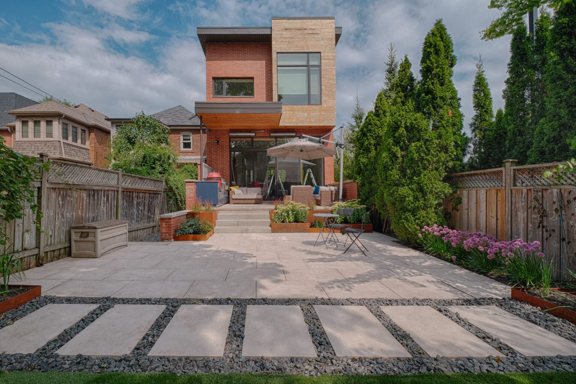 A stone backyard patio with a an attractive minimalist design.