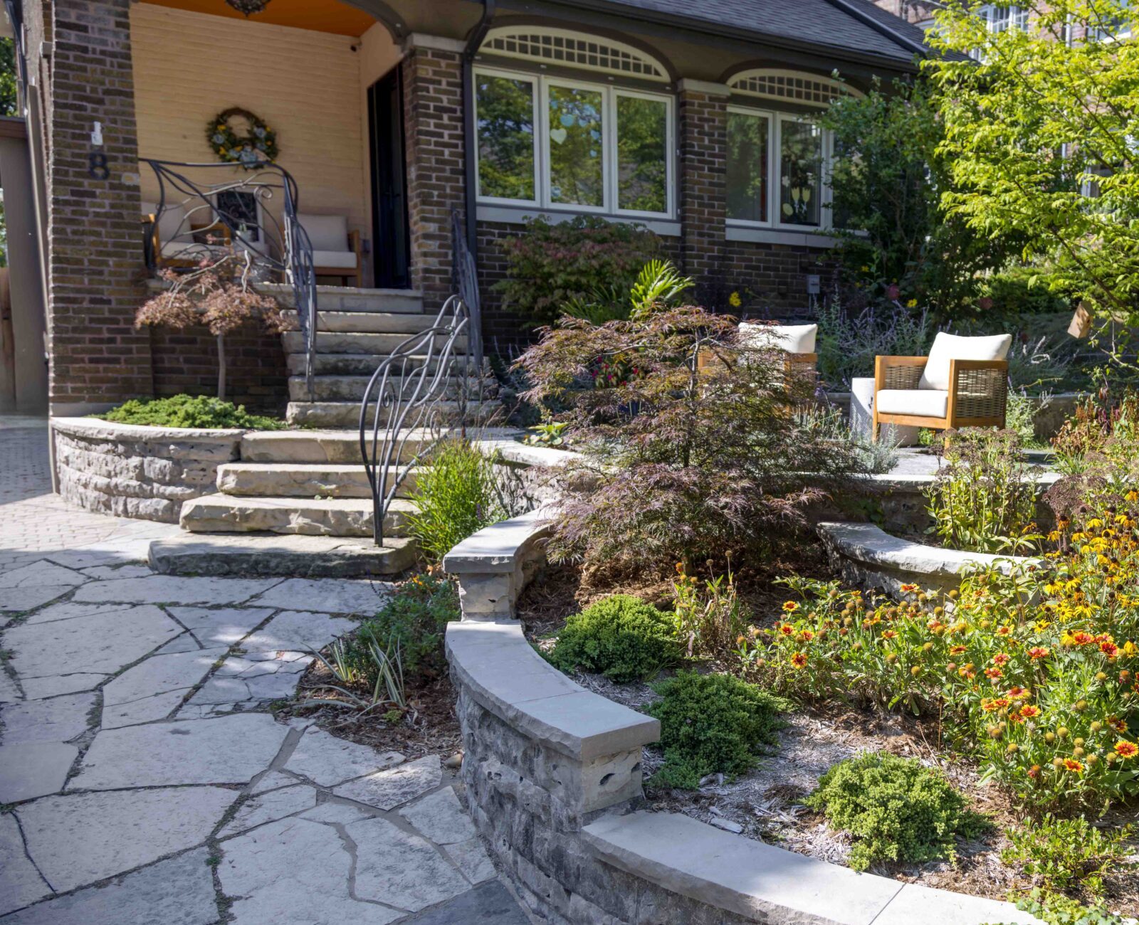 Xeriscaping featuring a terraced garden and custom stonework.